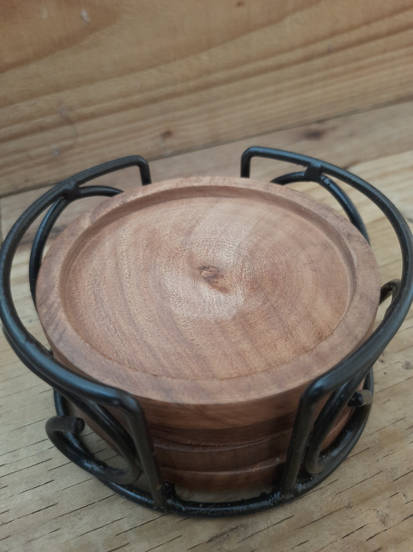 Mango wood coaster set with black metal holder styled for the home
