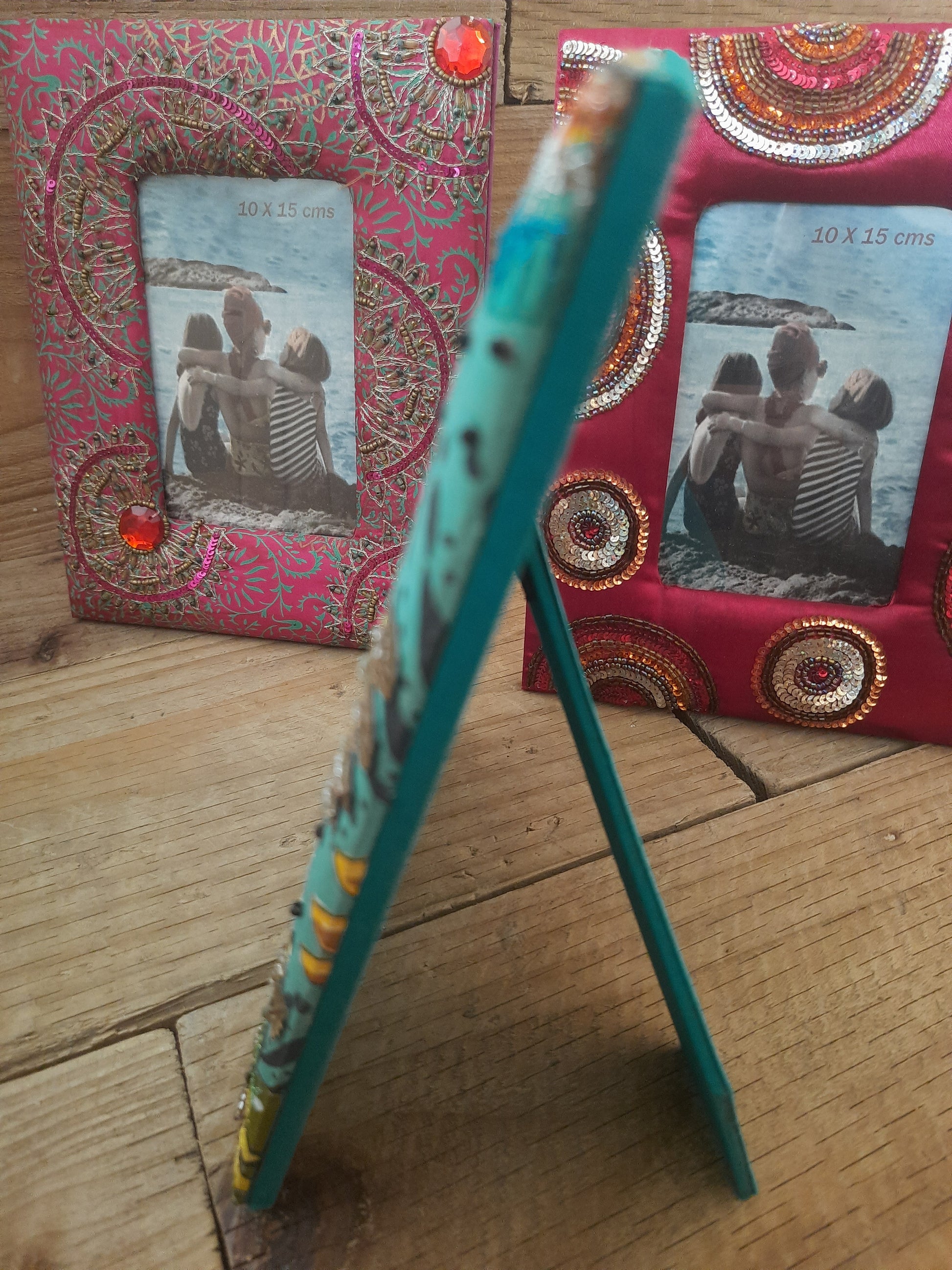 Green floral photo frame showing decorative fabric