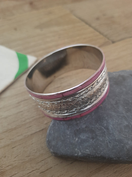 Close up of pink and silver floral bangle