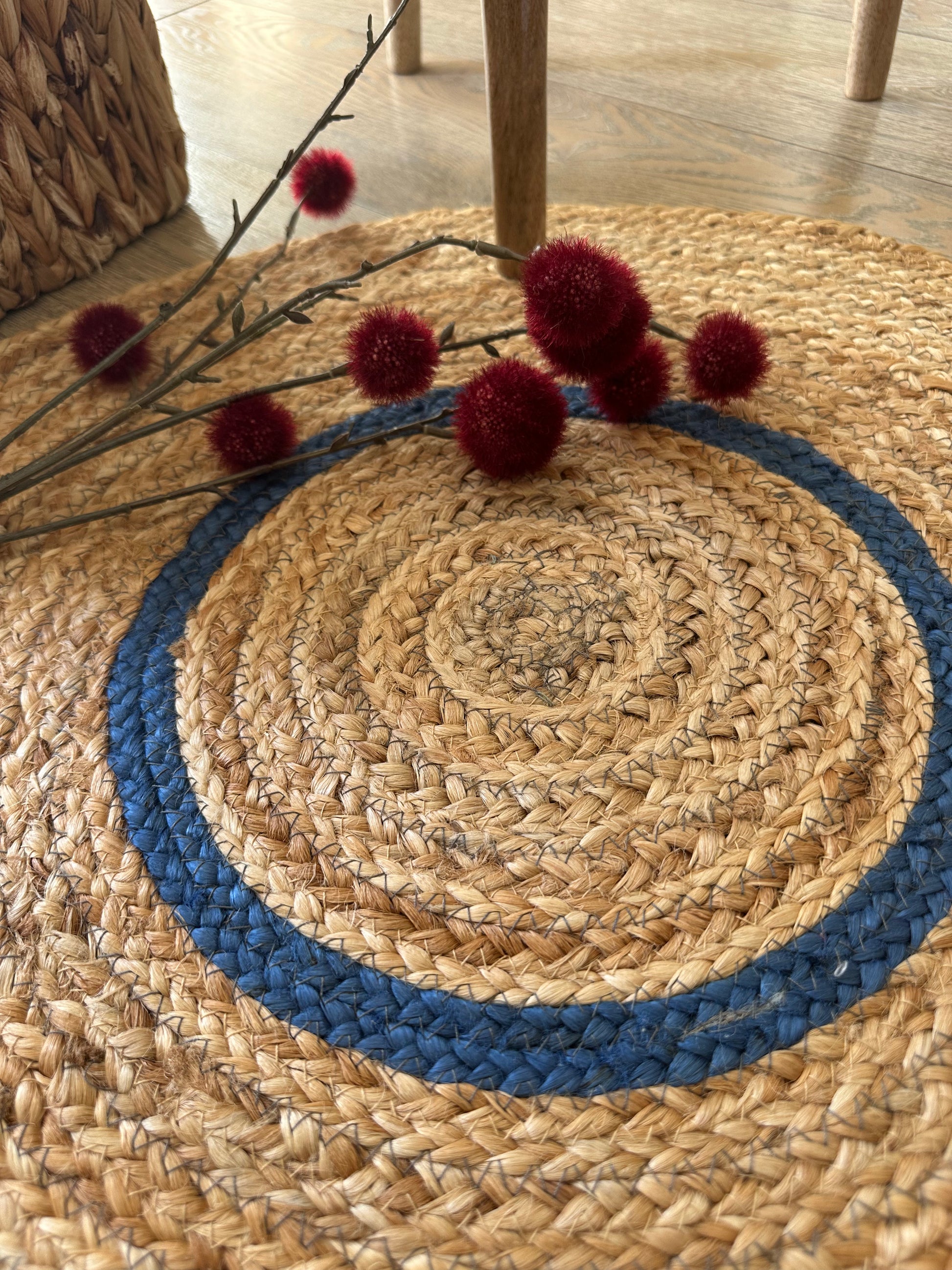 Close-up of blue detail on beige jute rug