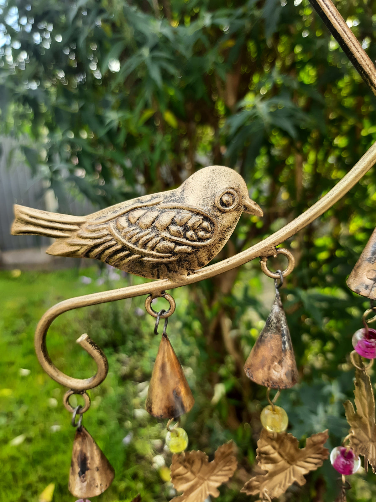 Recycled iron bird wind chime with decorative leaves