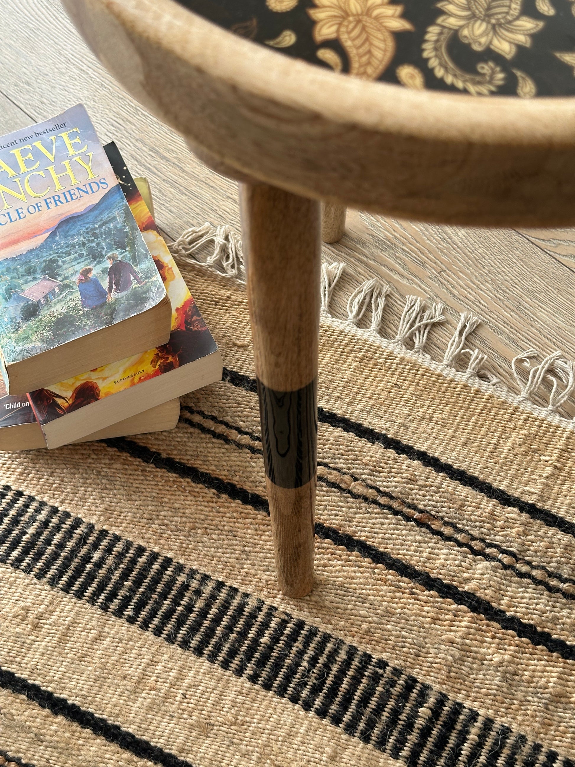 Black linear design across a beige cotton rug