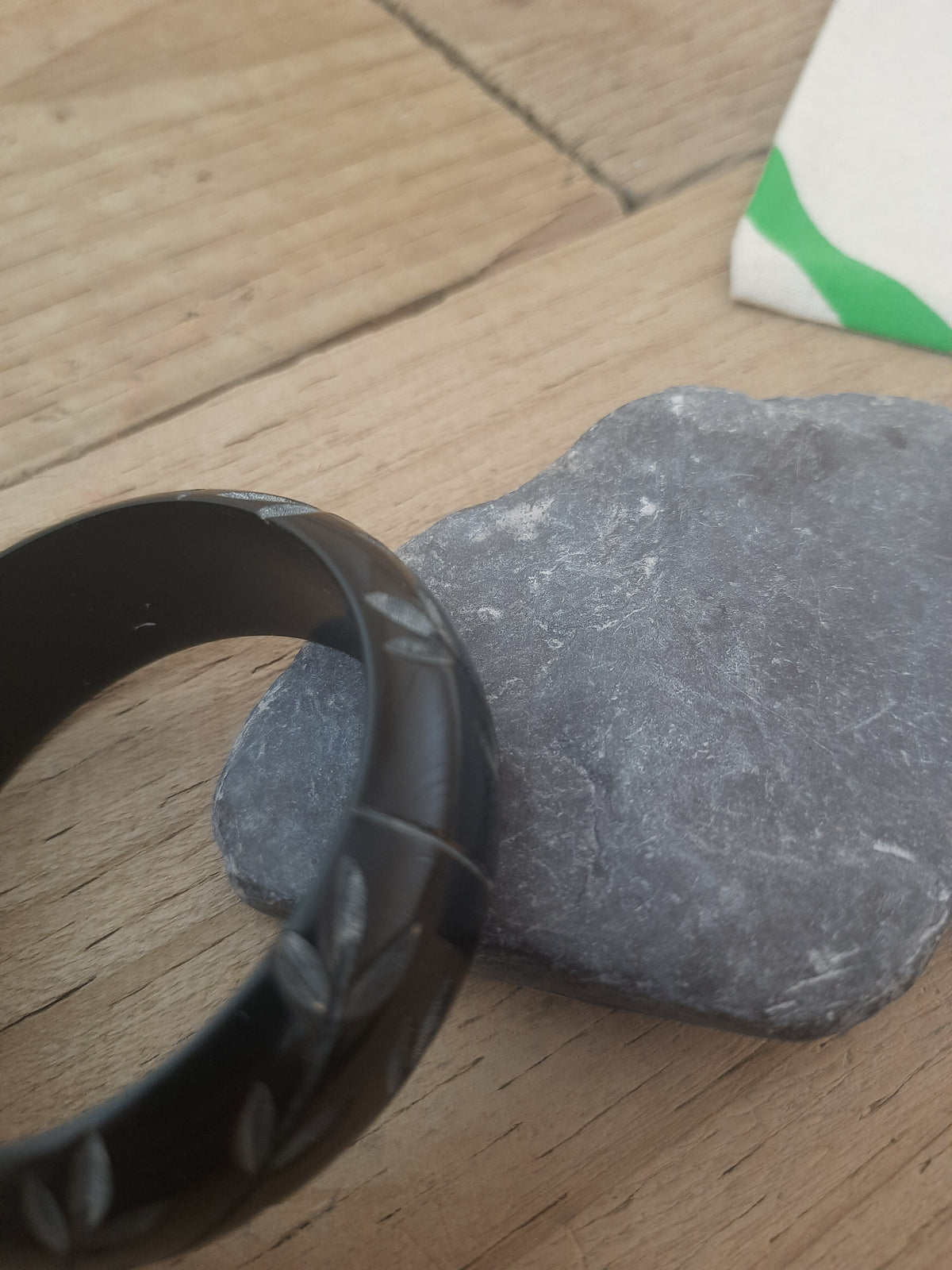 Black engraved floral bangle with flower accents