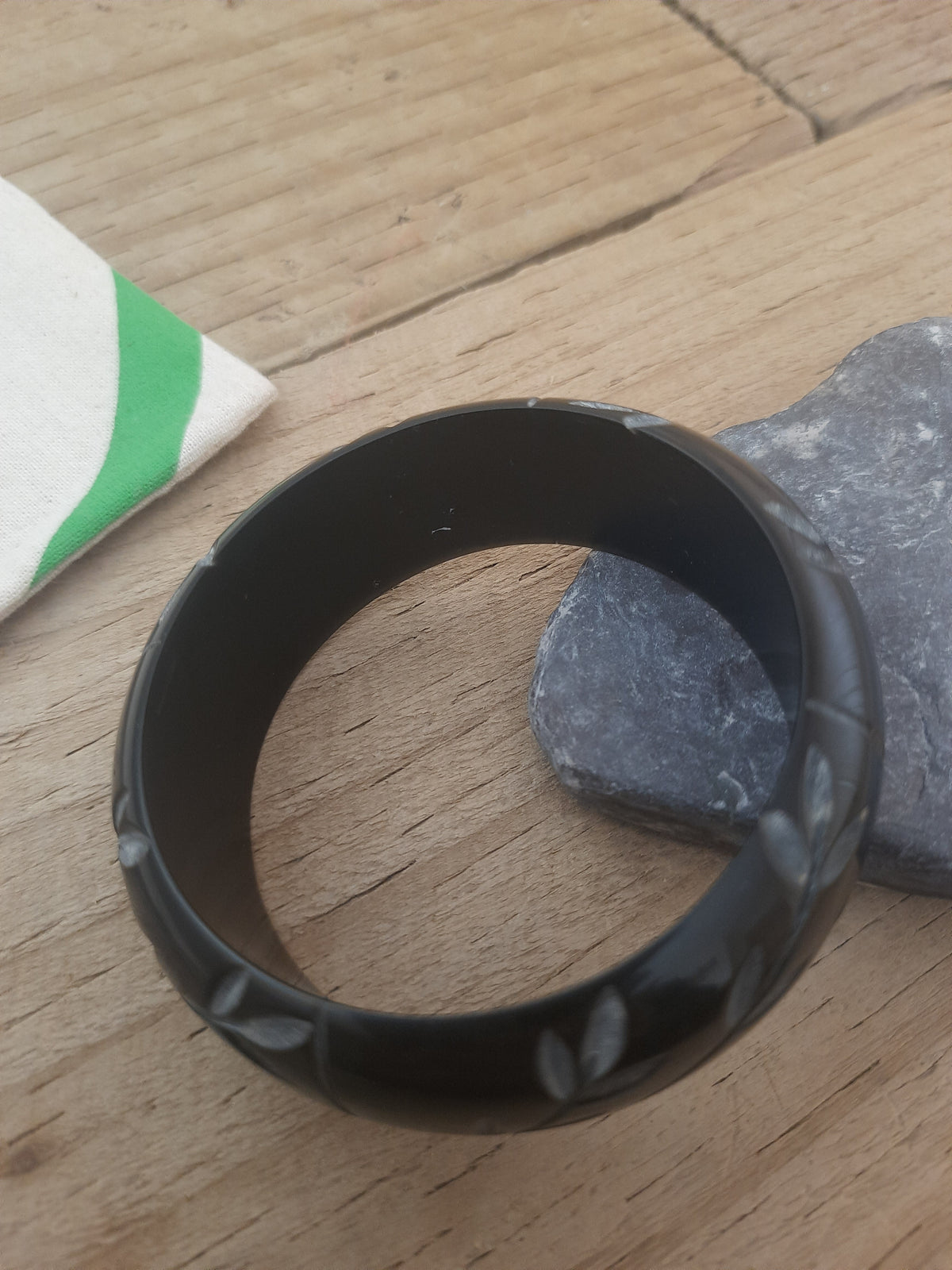 Elegant black bangle with flowing floral engraving