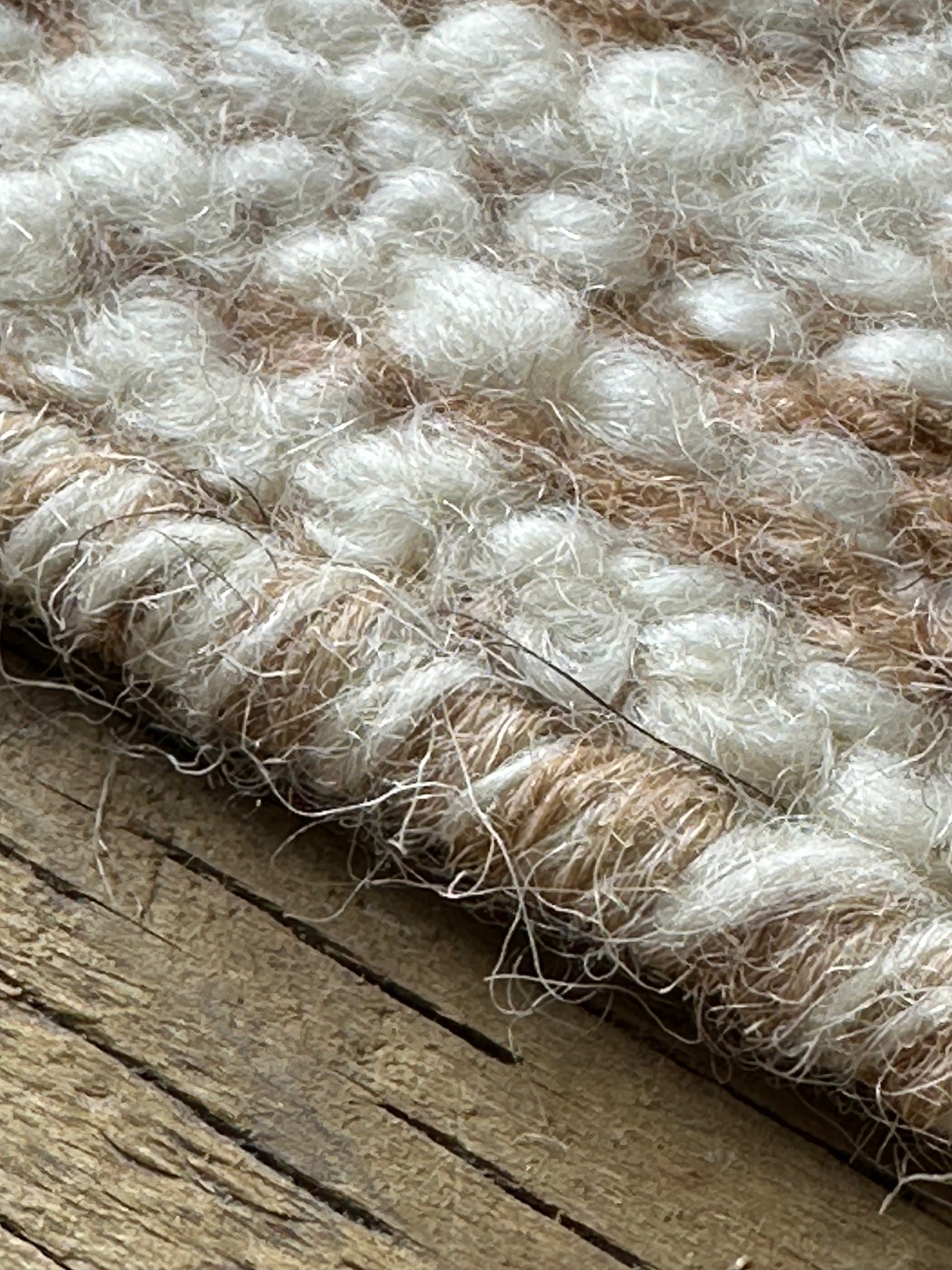 White and brown decorative rug with woven pattern