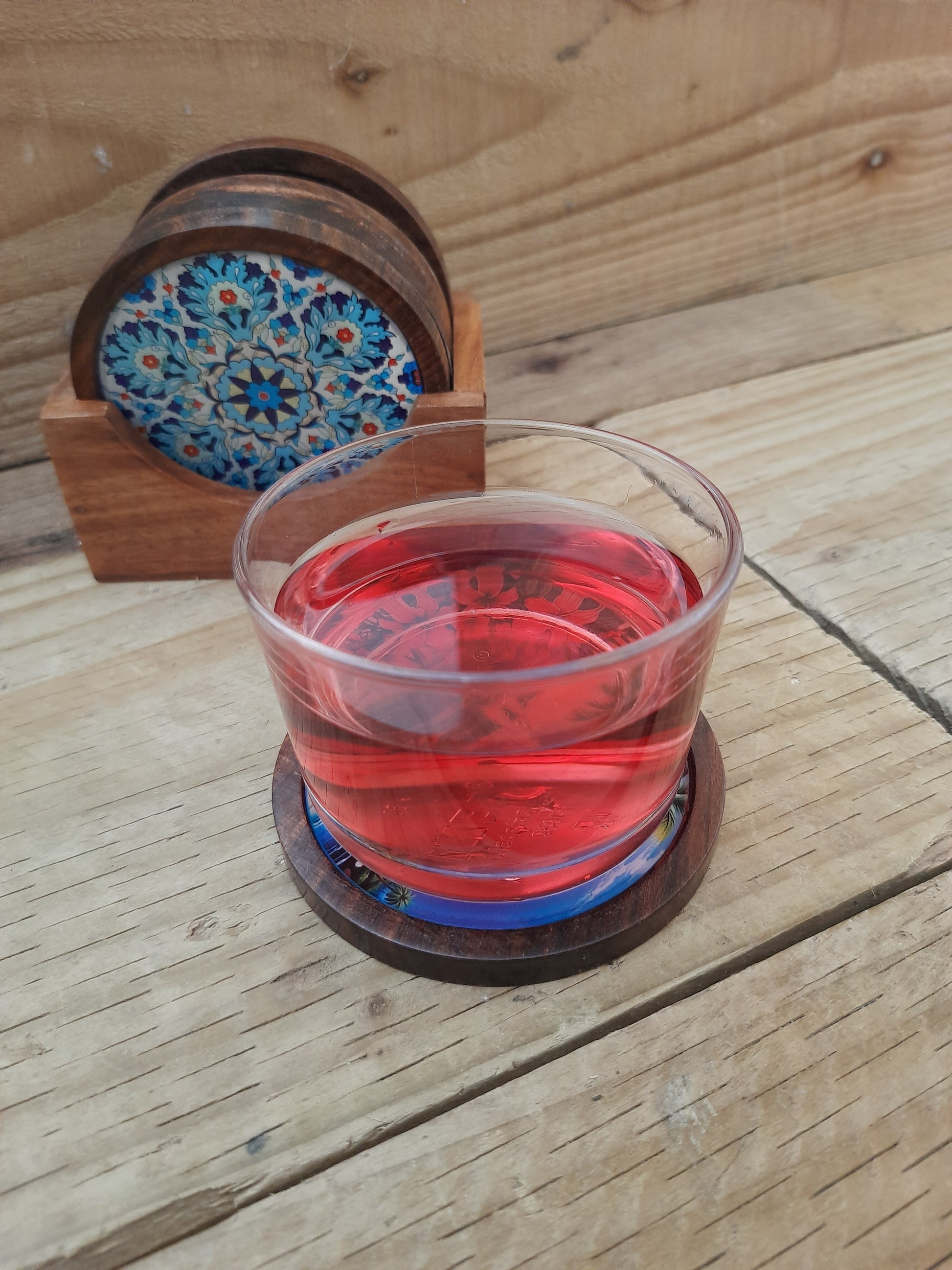 Set of six handcrafted wooden coasters with individual decorative designs