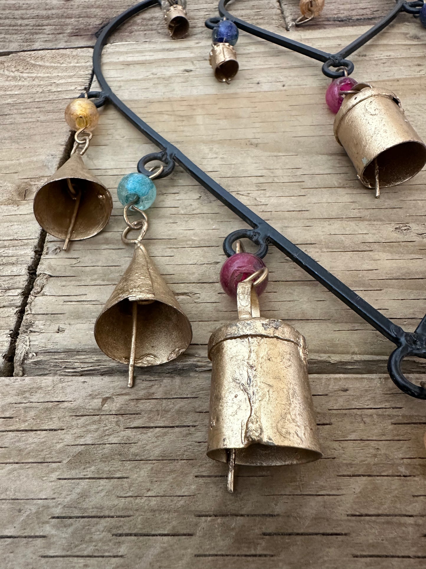 Double connected heart wind chime hanging in a garden