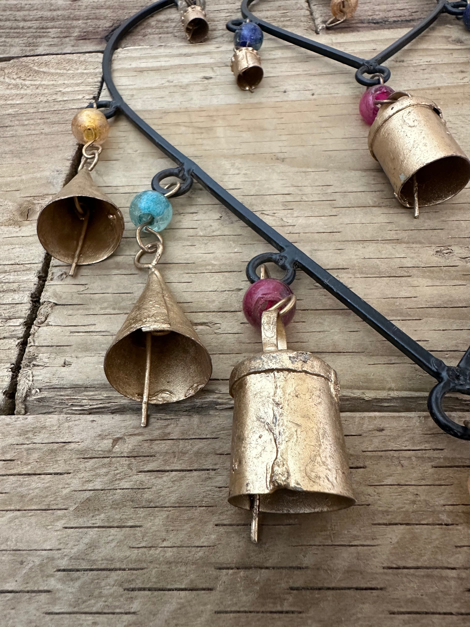 Double connected heart wind chime hanging in a garden
