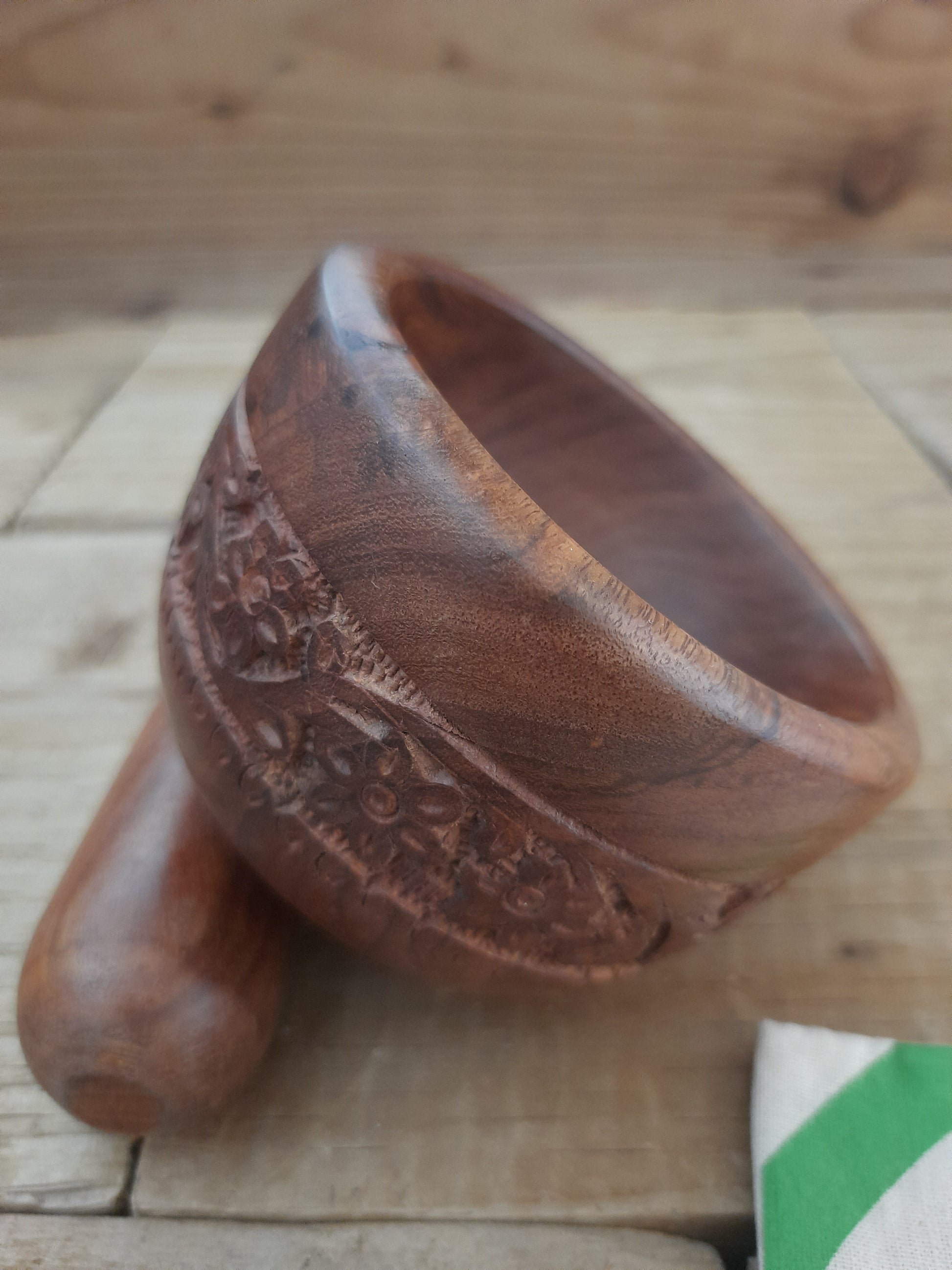 Engraved wooden mortar and pestle with floral detailing