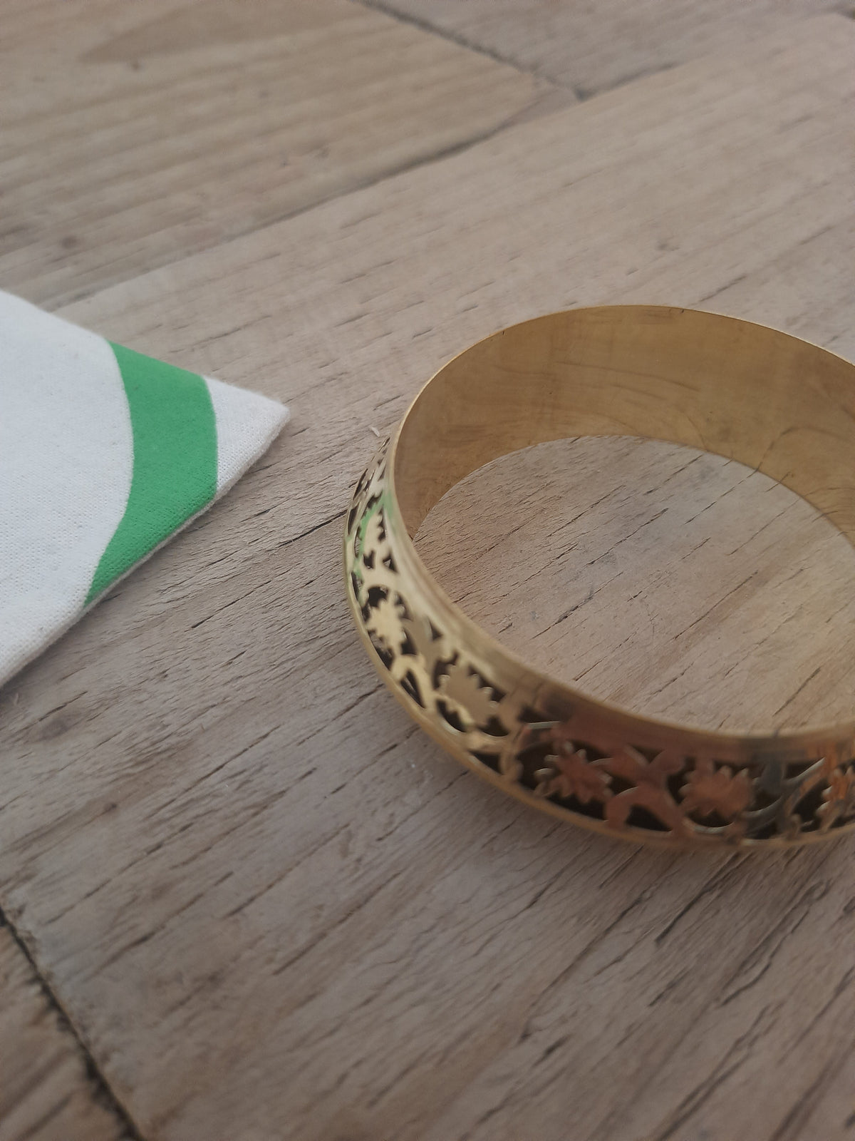 Gold bangle showing its decorative floral design