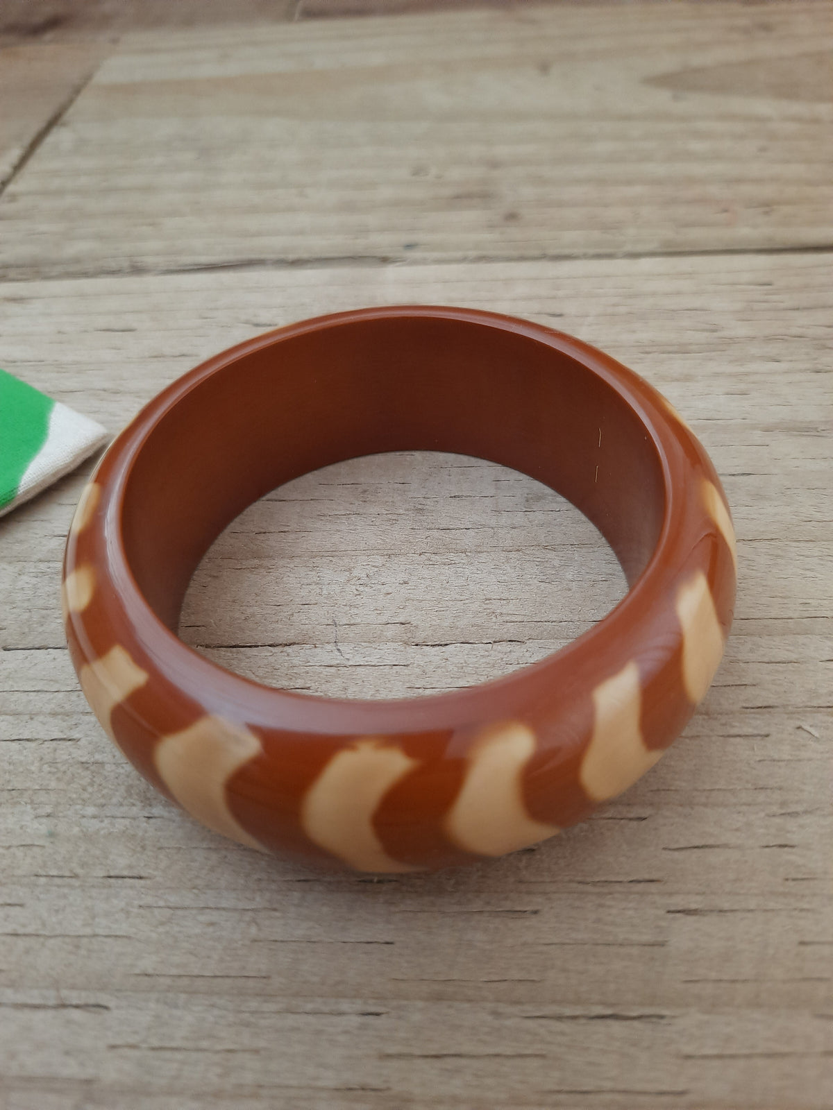Brown and light brown bangle showing its wavy pattern