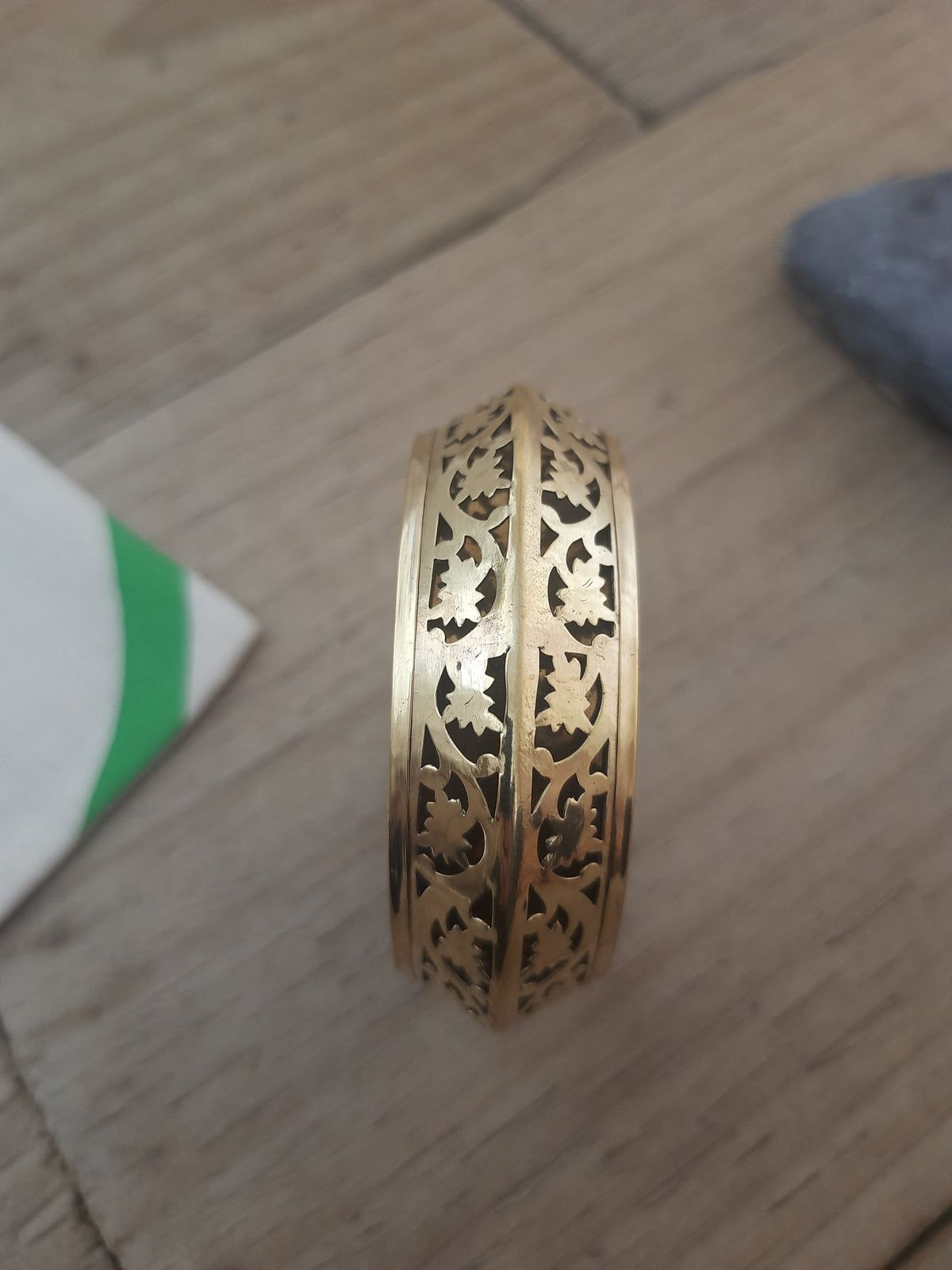 Artisan gold floral bangle with decorative detailing