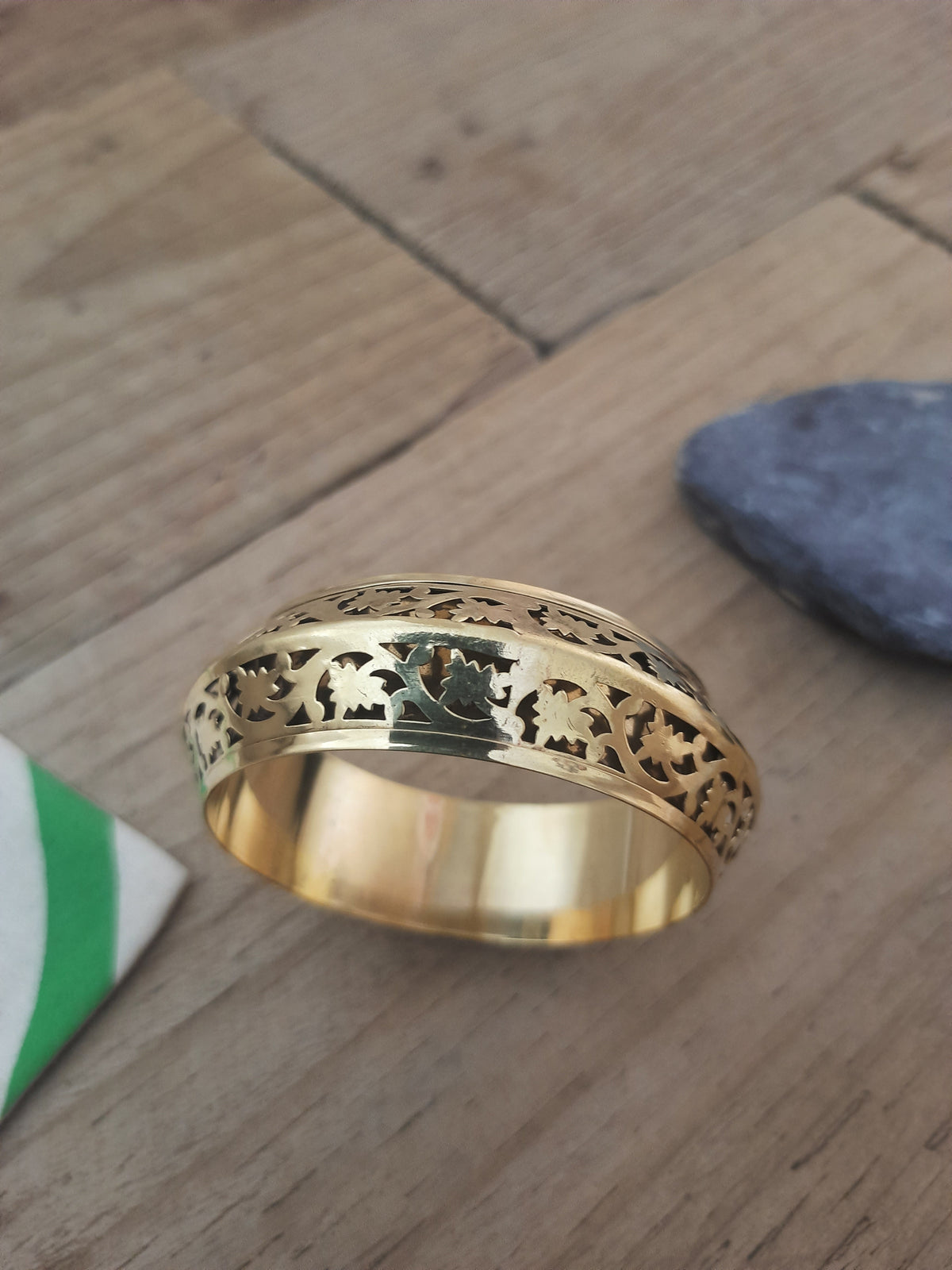 Gold statement bangle with detailed floral pattern