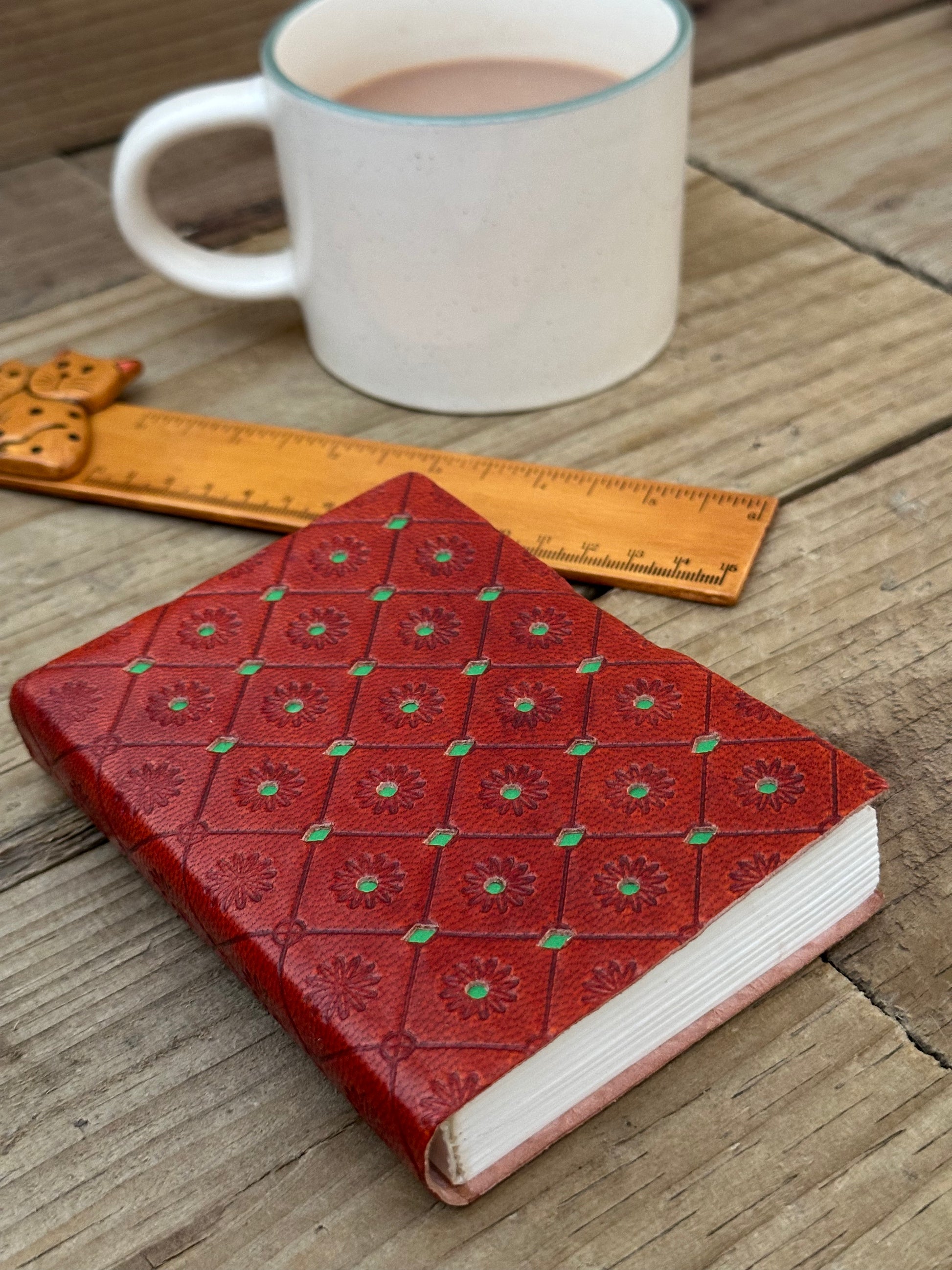 Green mini leather notebook with embossed decorative cover