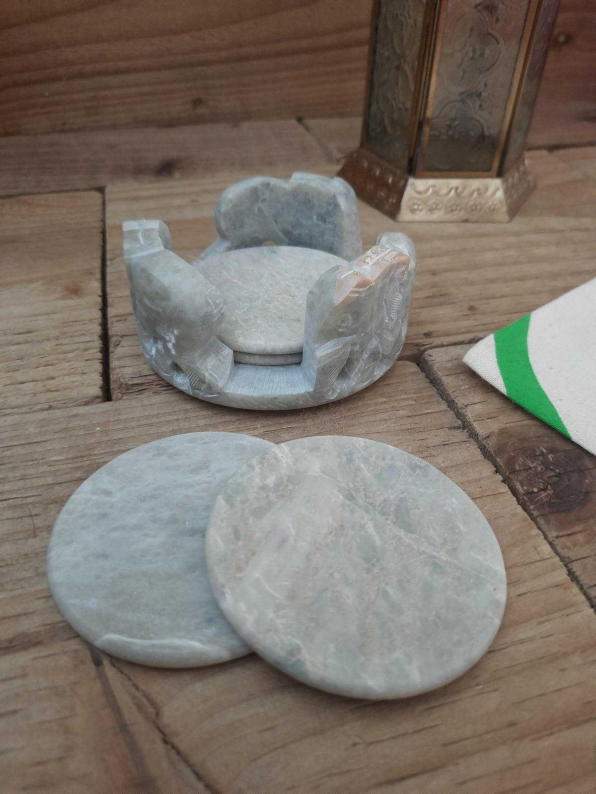 Six hand carved soapstone coasters with matching holder