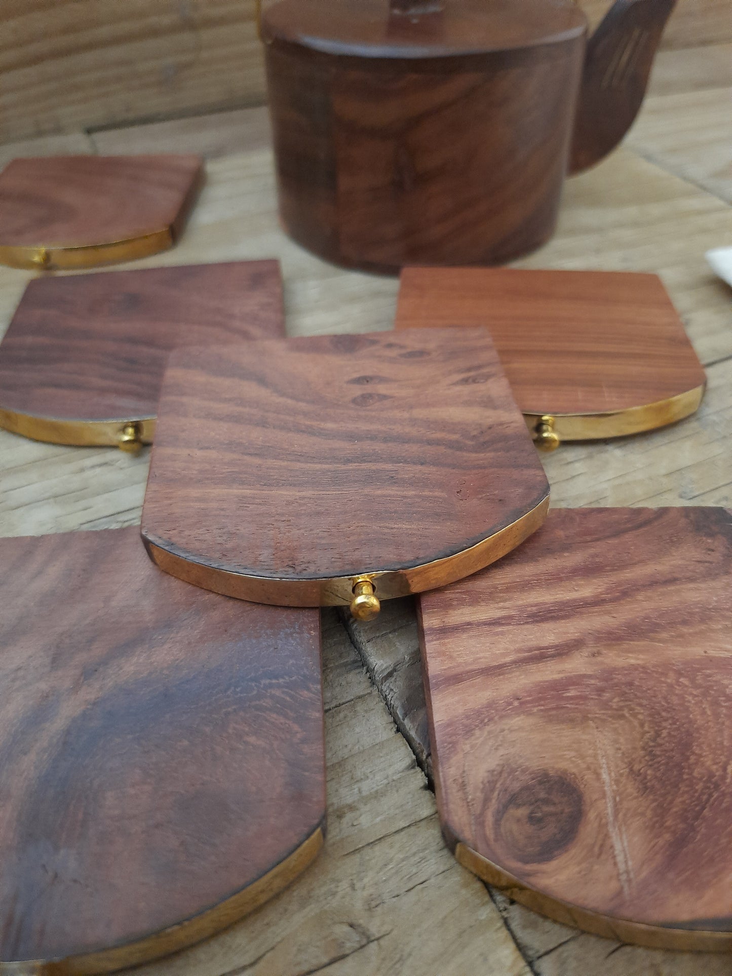 Close-up detail of rosewood coaster with brass inlay