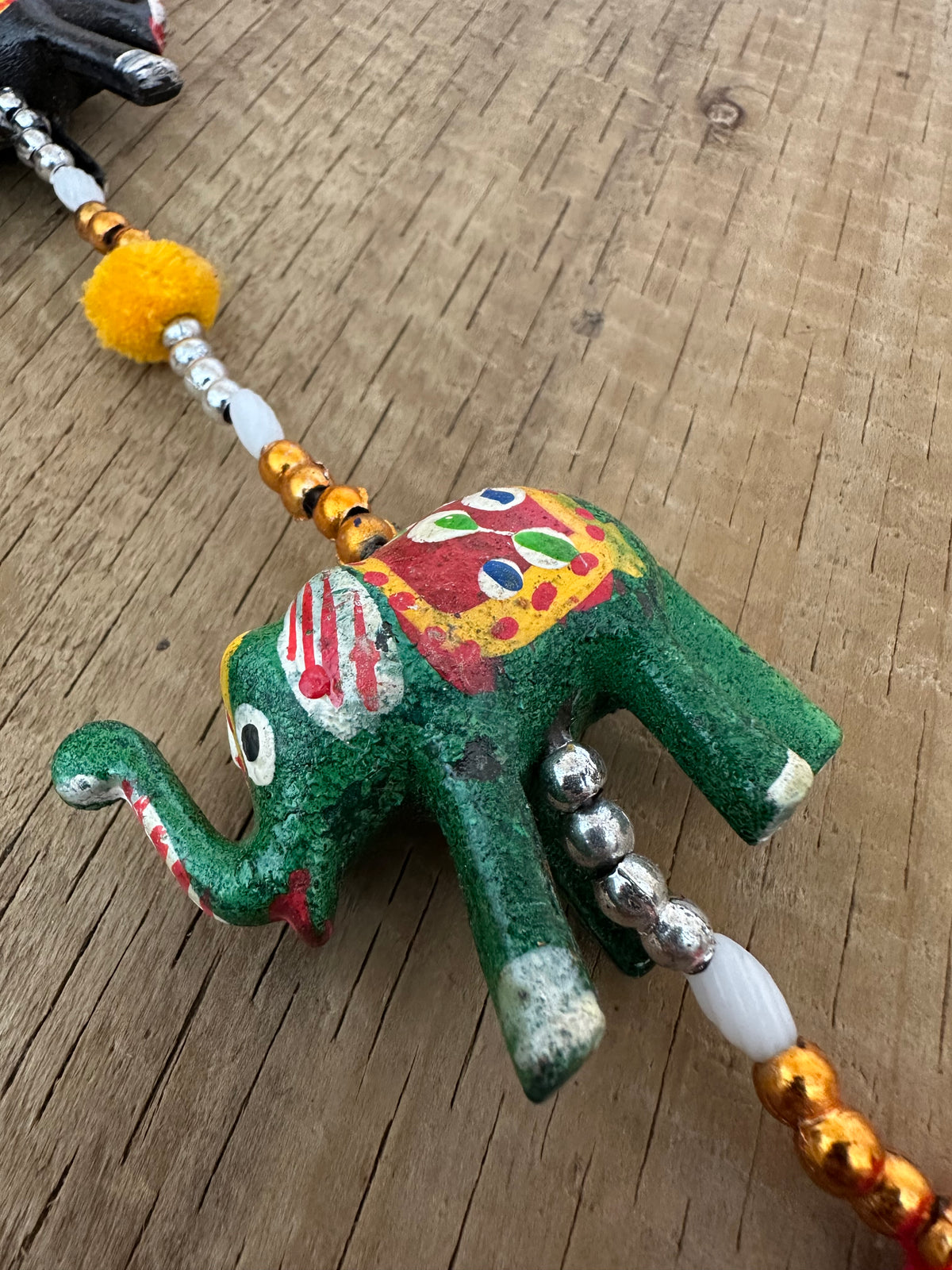 Colourful beaded string with wooden elephants