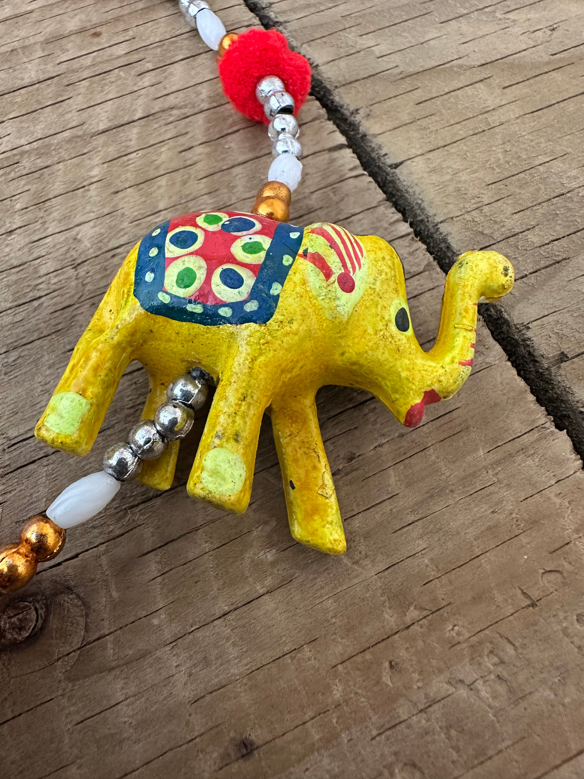 Gold and white bead detailing on elephant hanging