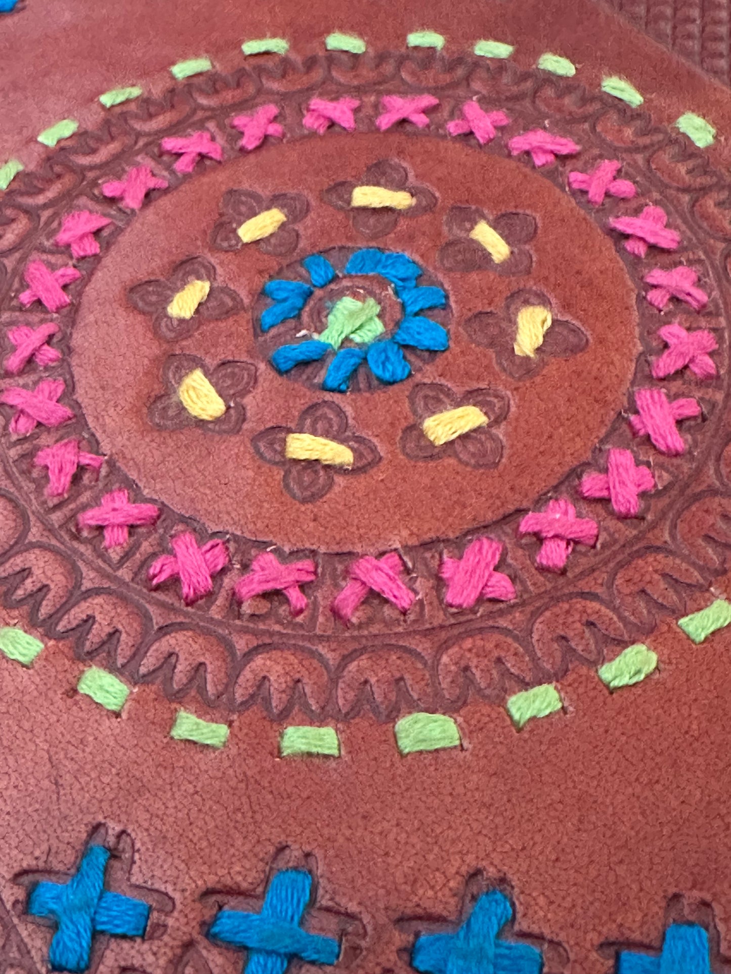 Leather-bound notebook with cotton detailing on front cover