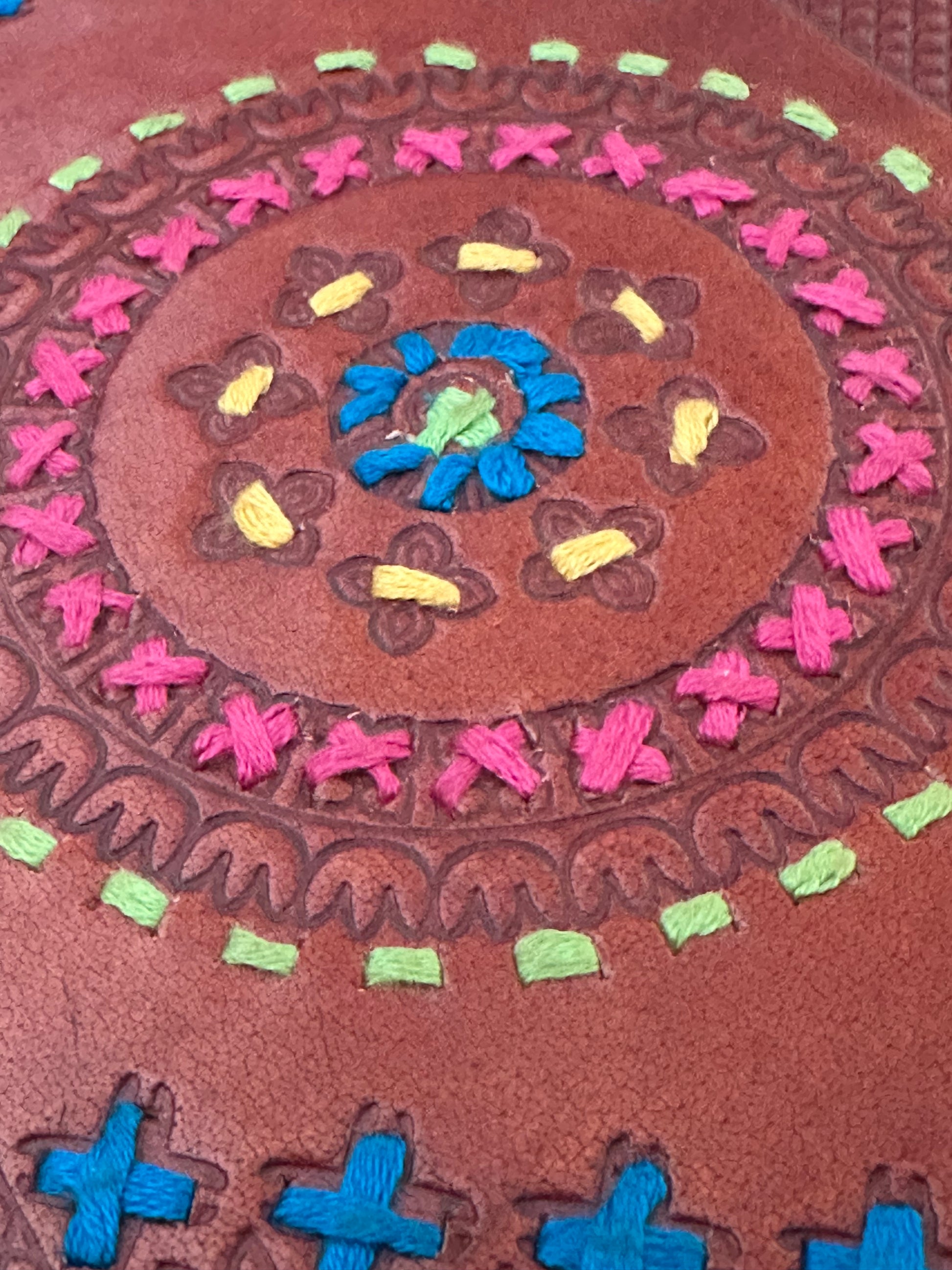 Leather-bound notebook with cotton detailing on front cover
