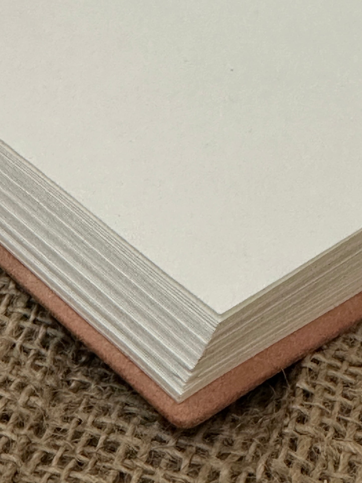 Open leather-bound notebook showing handmade pages