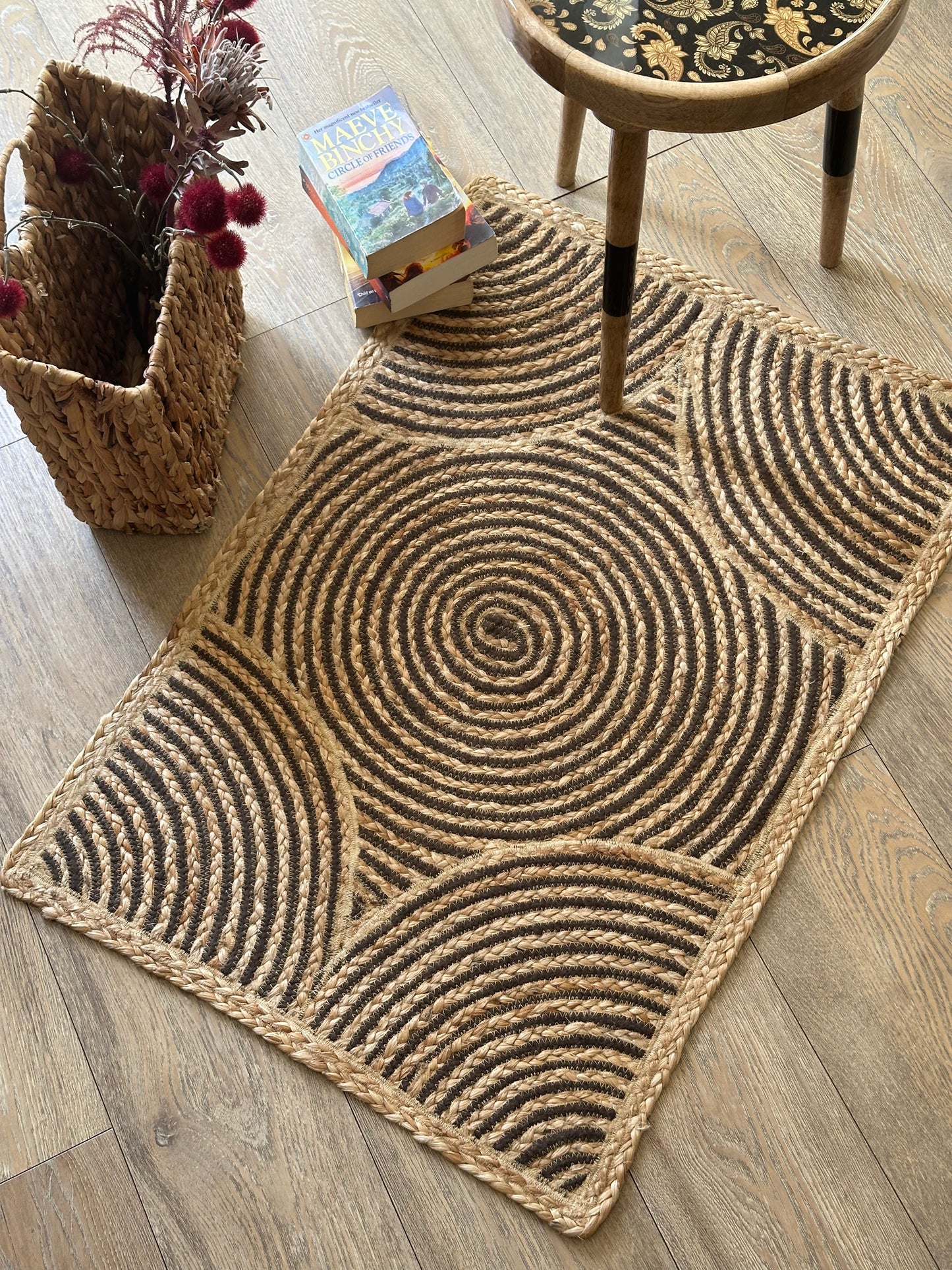 Light brown jute rug with swirling centre design