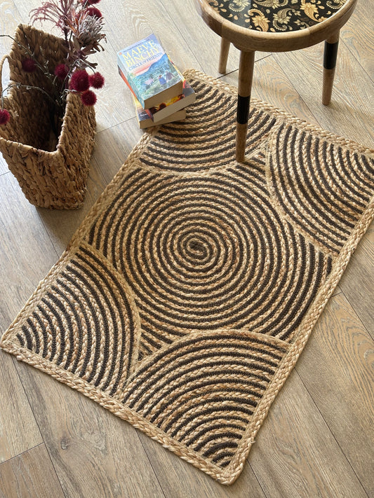 Light brown jute rug with swirling centre design