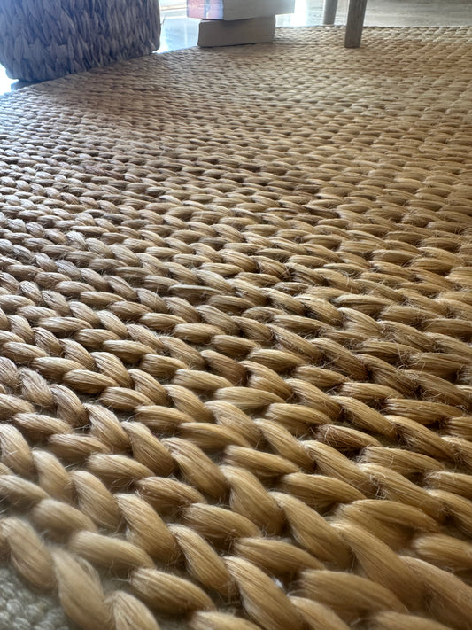 Light brown handmade jute rug with textured pattern