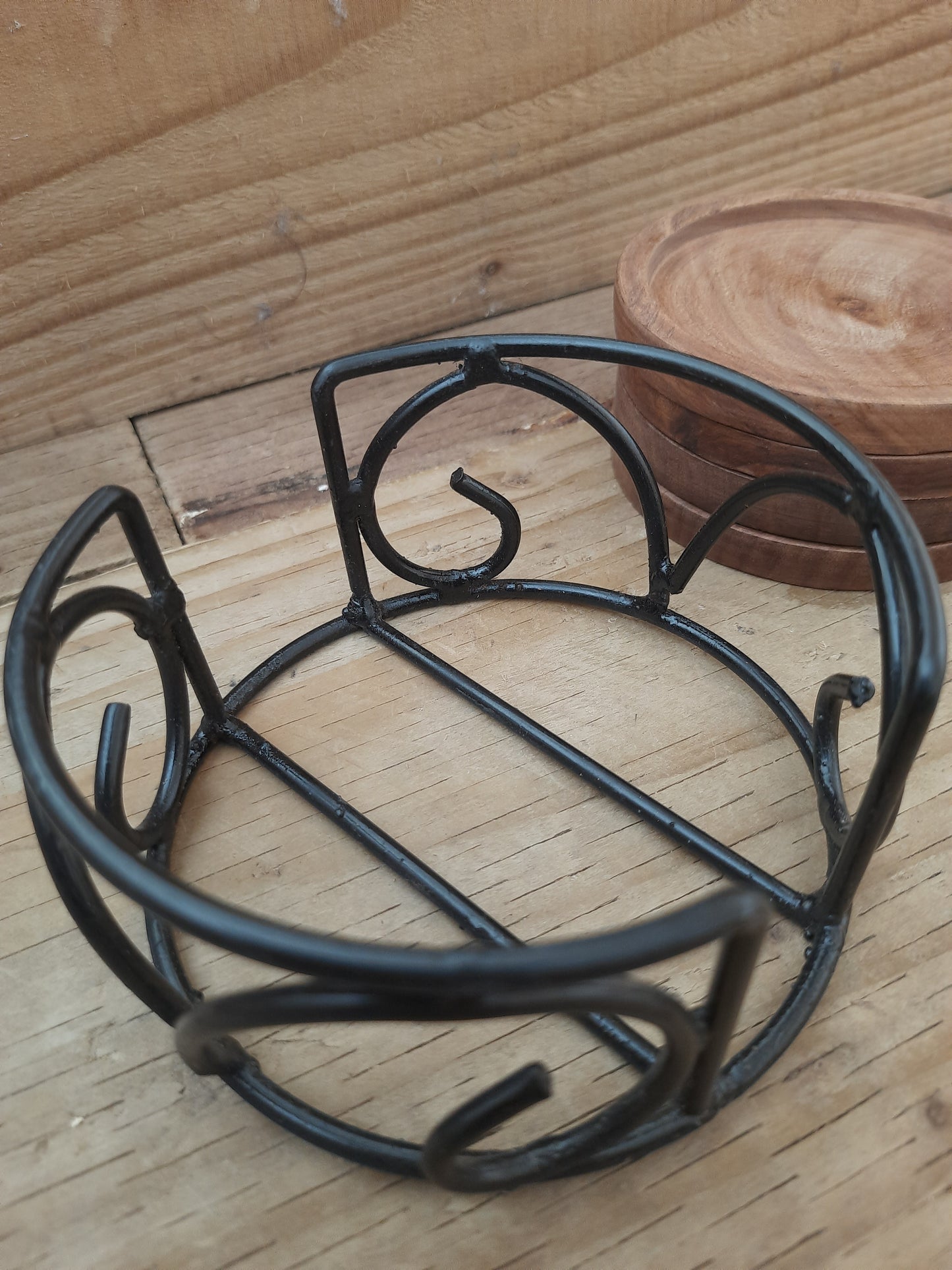 Mango wood coasters displayed in black powder-coated 