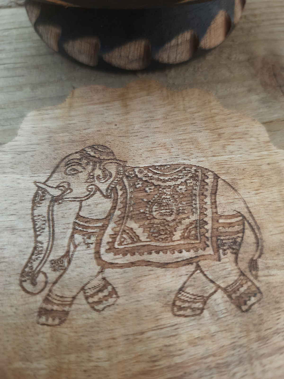 Close-up of handmade detail on mango wood coaster