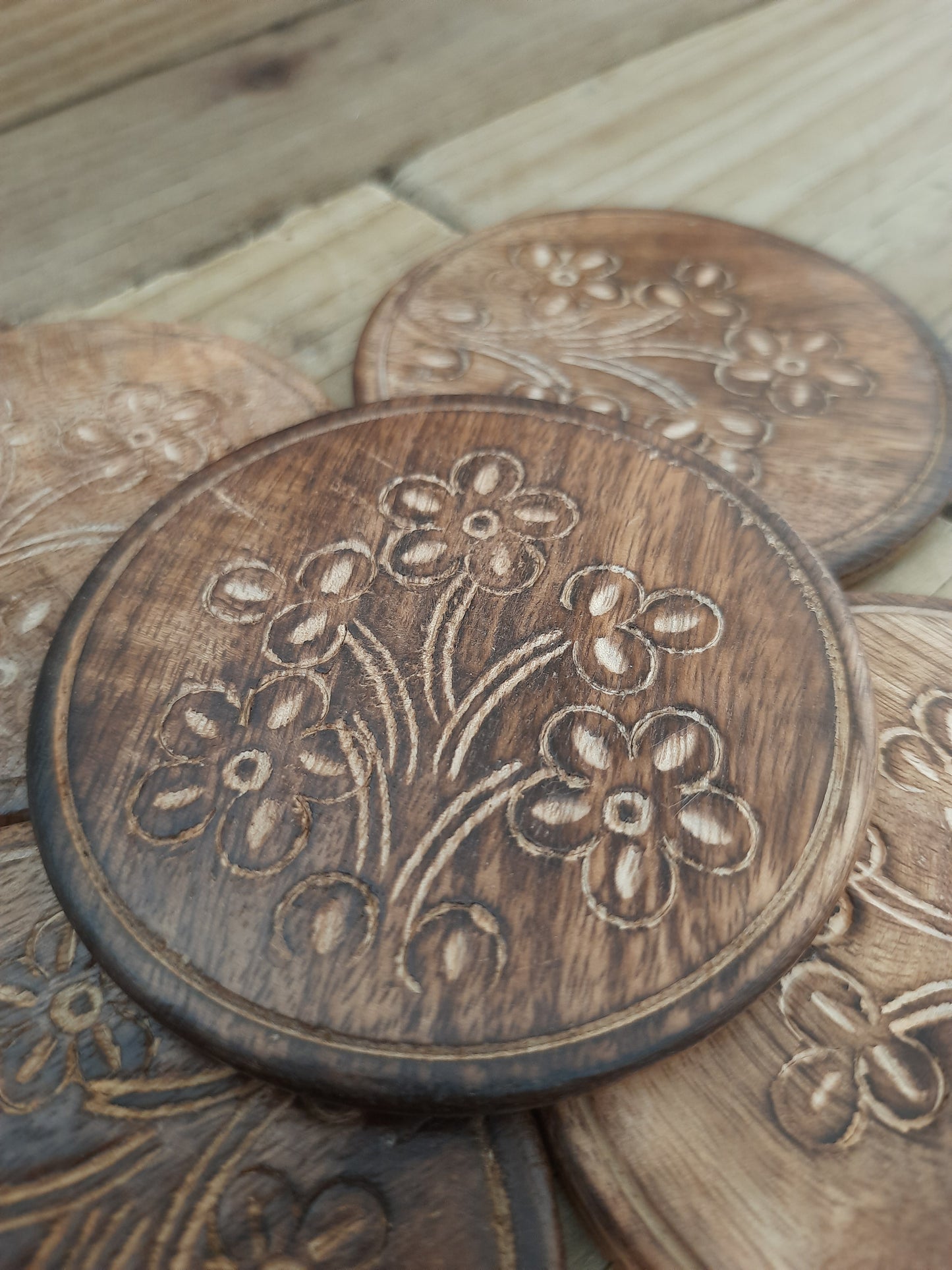 Rustic mango wood coasters with floral detailing