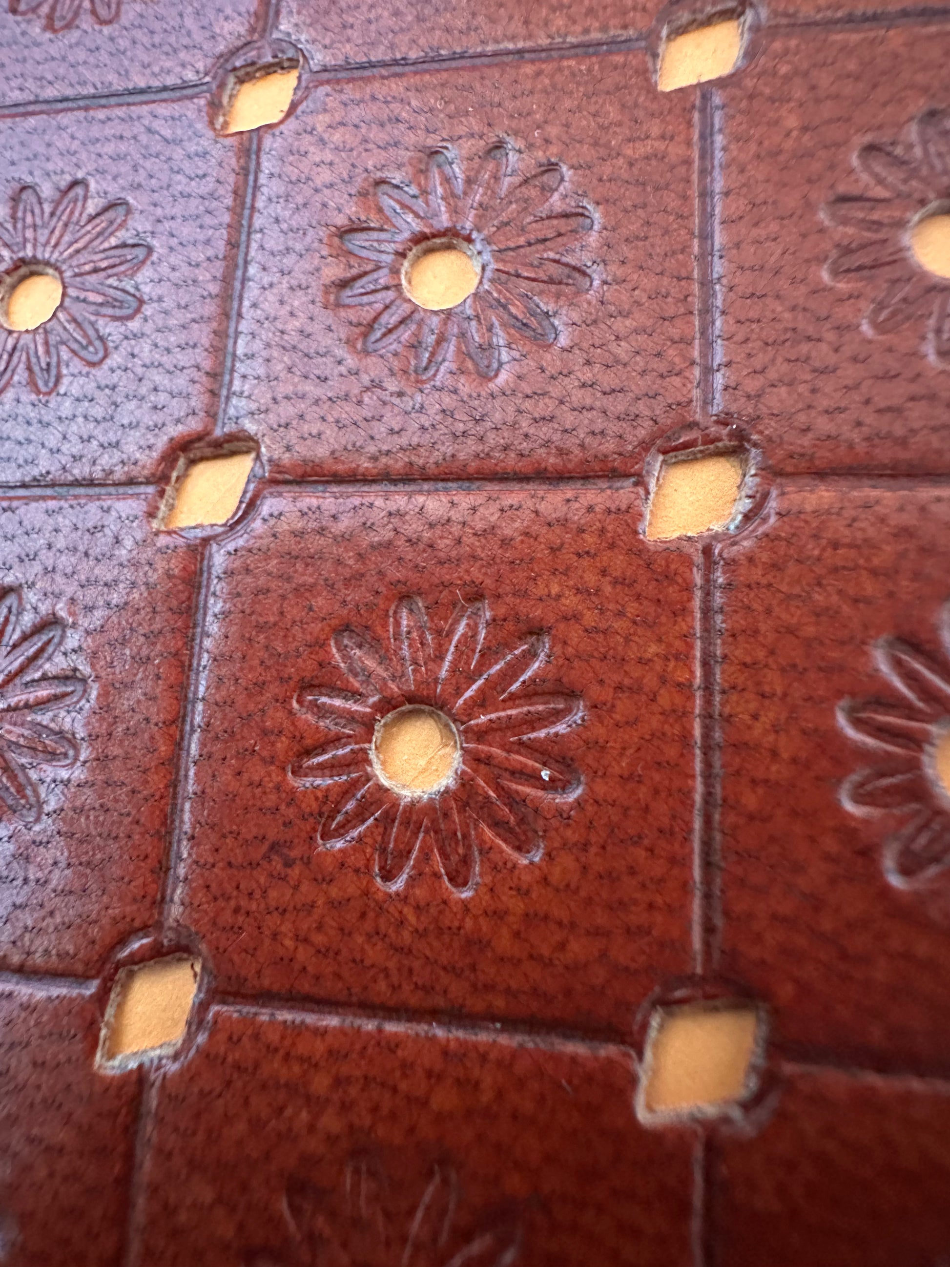 Close-up of textured orange leather cover on mini notebook