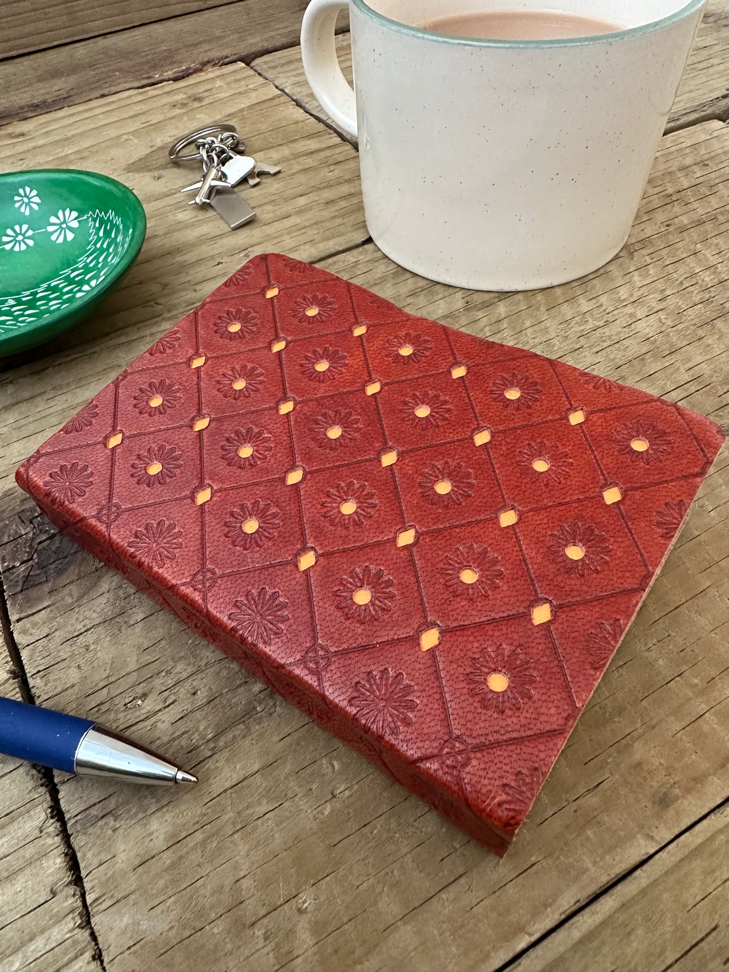 Close-up of handmade recycled cotton paper inside orange leather notebook