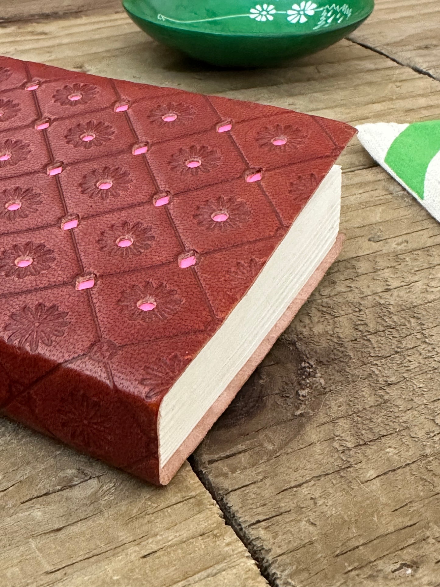 Pink mini leather notebook showing leather binding detail