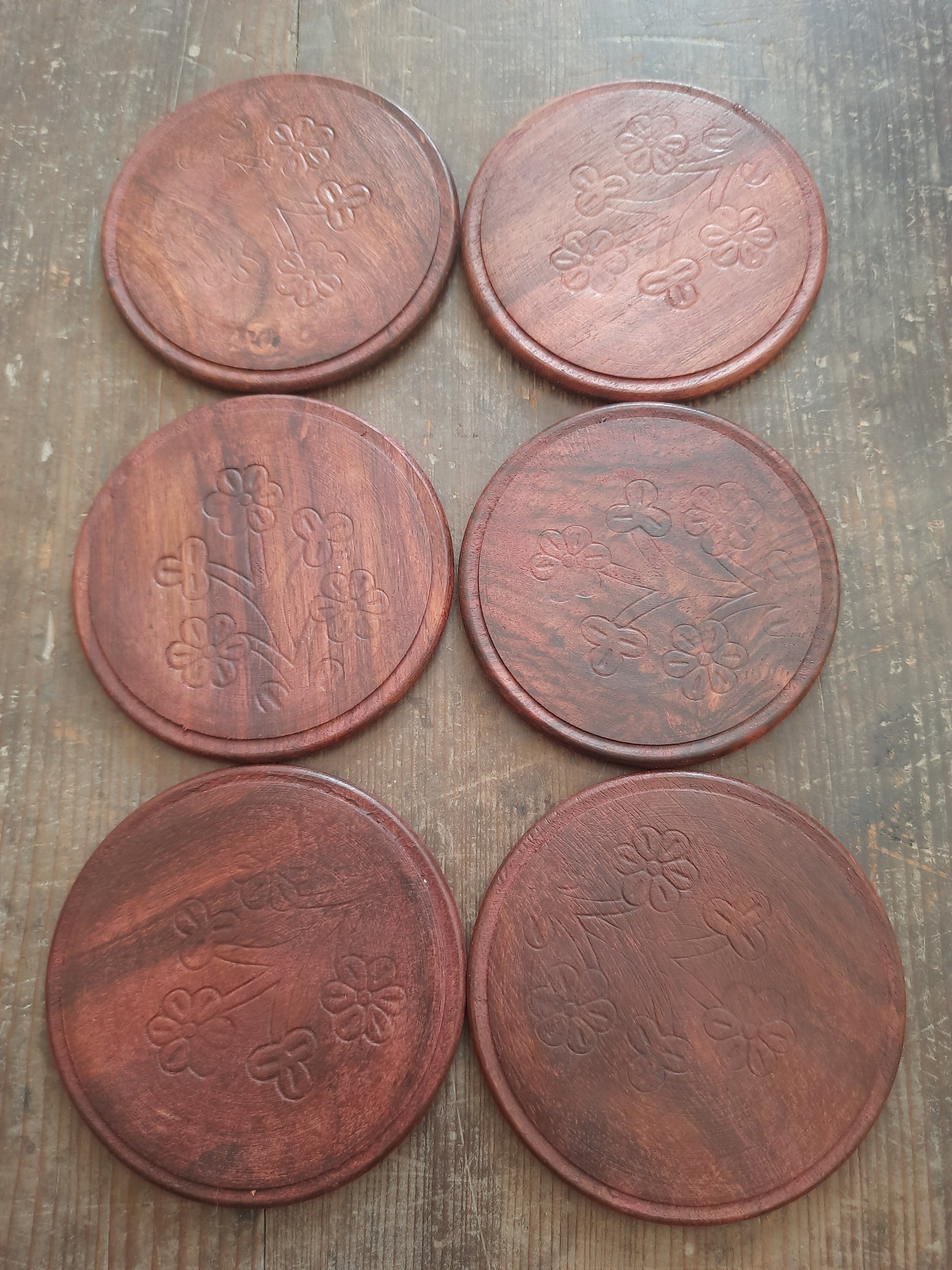 Six natural rosewood coasters displayed as a complete set