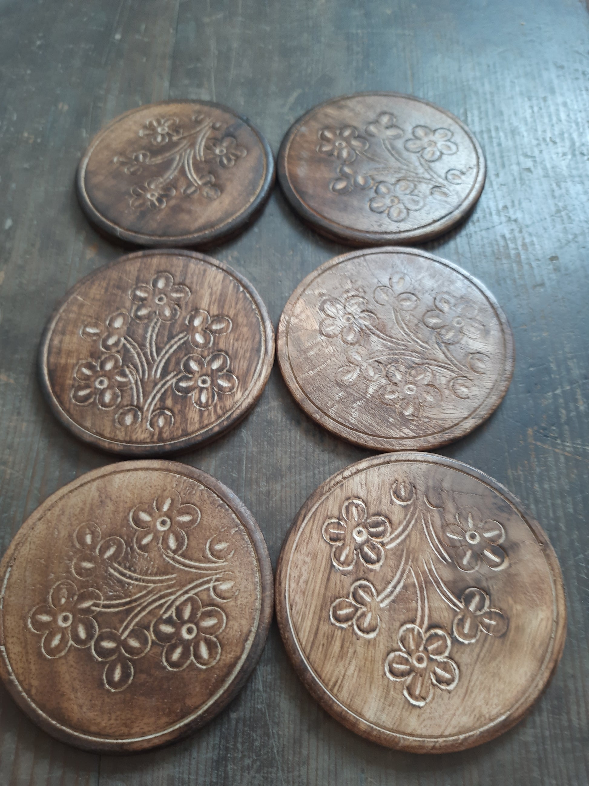Mango wood coasters showing their detailed flower design