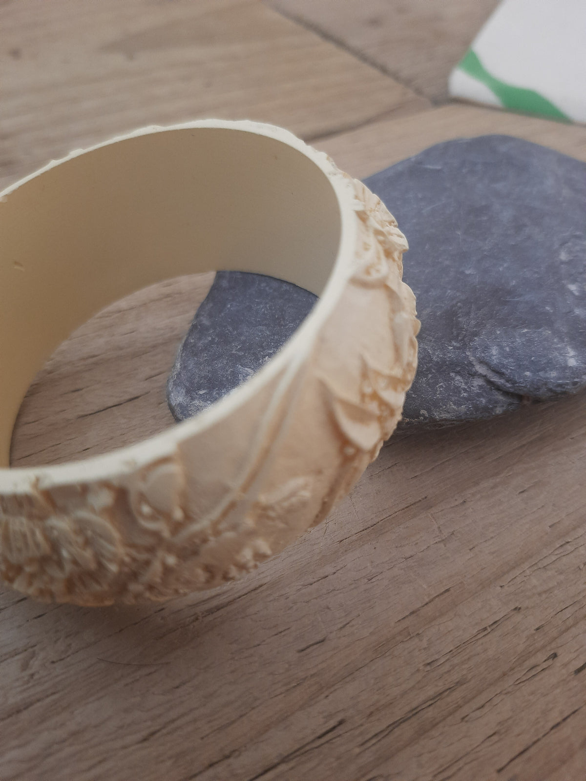 Wide off-white bangle with tactile engraved detailing